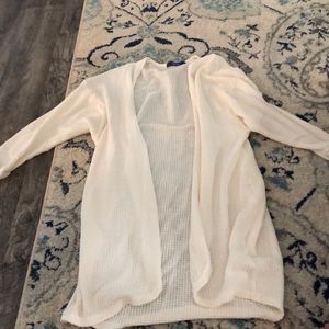 cream colored, quarter length sleeve cover jacket